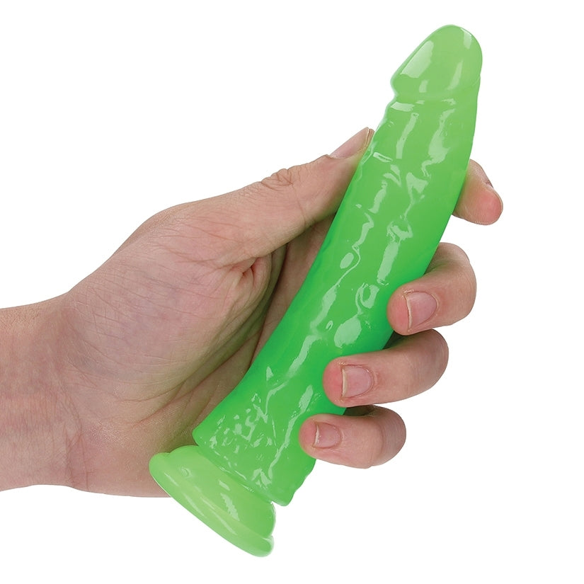 Hand holding a Realrock Glow In The Dark Slim 6 Inch Dildo - Neon Green